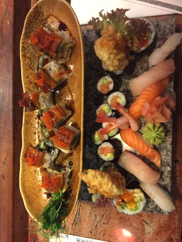 Glazed unagi rolls alongside salmon and white-fish nigiri