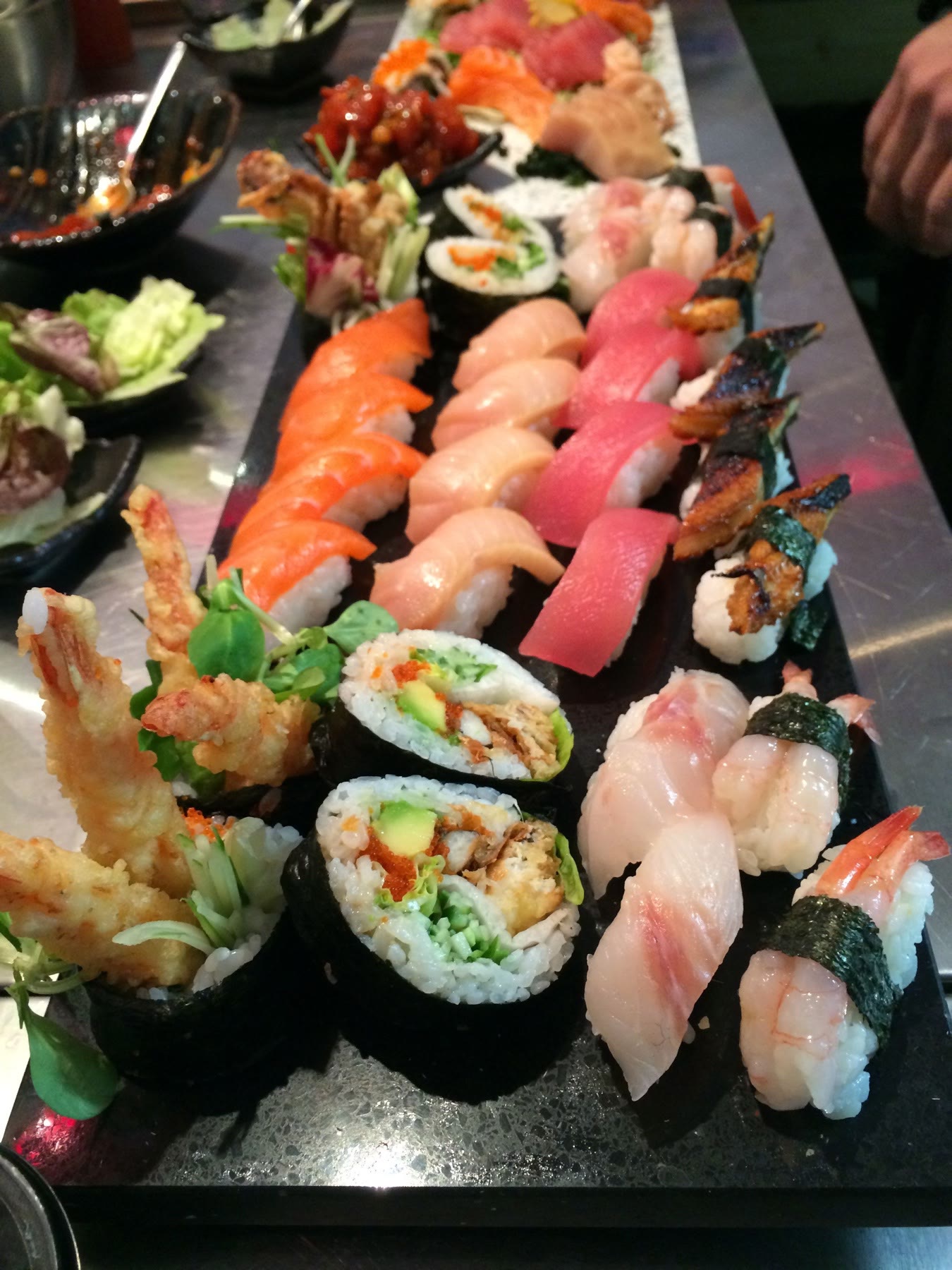 A close view of assorted nigiri, maki and tempura sushi