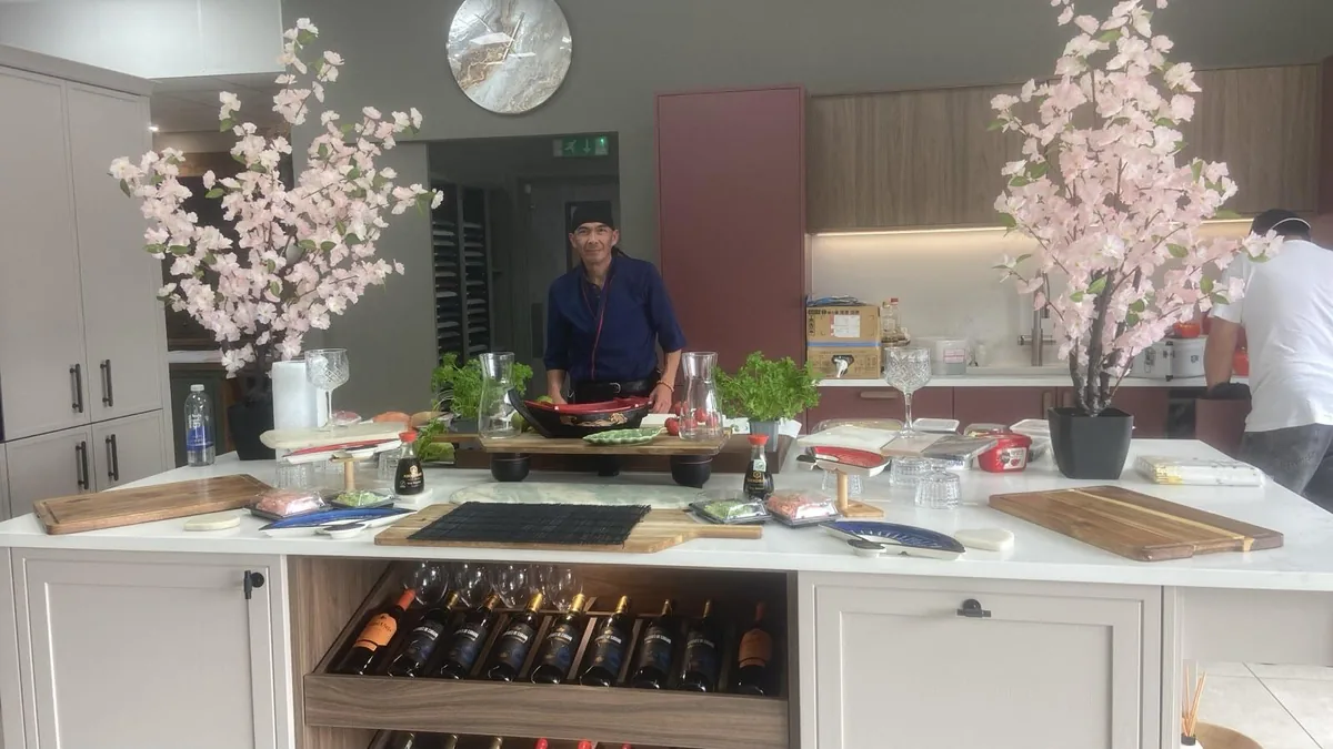 Chef Cisco setting out serving boards and a sushi boat before an event